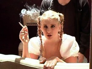 Pigtailed Blonde Gets Hammered From Behind While Smoking A